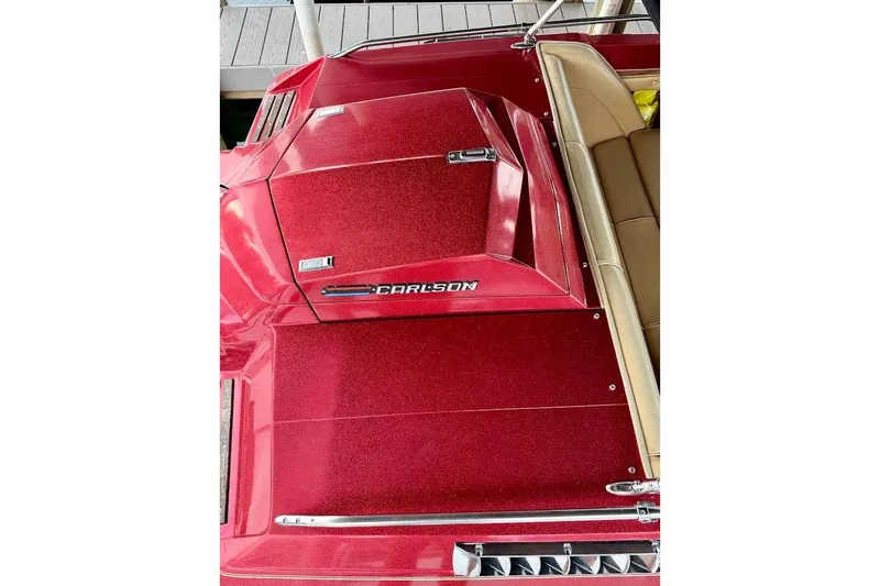 Slide: The Image of 1981 Glastron/Carlson C512 boat with red metallic finish and beige seating. - 23