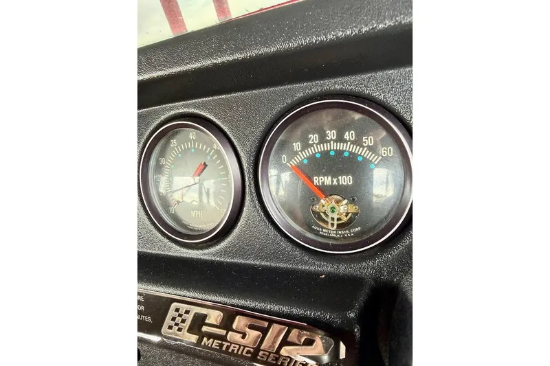 Slide: The Image of 1981 Glastron/Carlson C512 dashboard with speedometer and RPM gauges. - 32