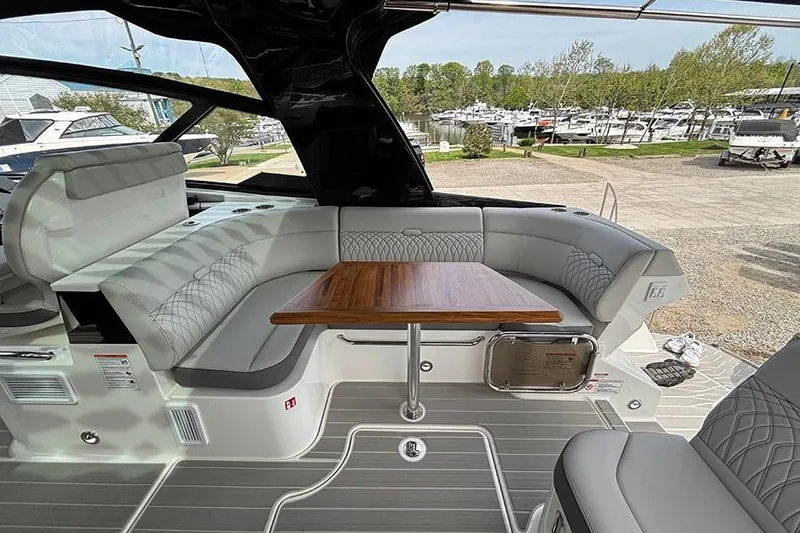 Slide: The Image of Luxurious interior of 2026 Sea Ray Sundancer 370 Outboard with elegant seating and wooden table. - 10