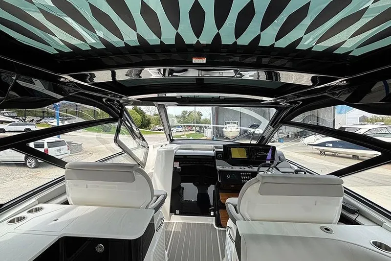 Slide: The Image of Interior view of 2026 Sea Ray Sundancer 370 Outboard, featuring modern helm and seating. - 15