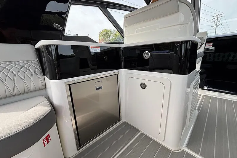 Slide: The Image of Interior view of 2026 Sea Ray Sundancer 370 Outboard, featuring sleek seating and cabinetry. - 16