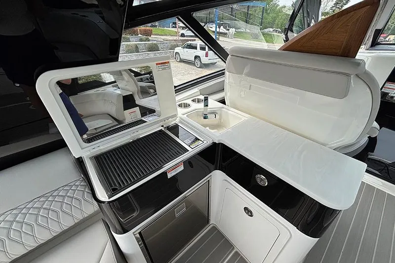Slide: The Image of Luxurious 2026 Sea Ray Sundancer 370 Outboard yacht interior with kitchenette and seating area. - 17