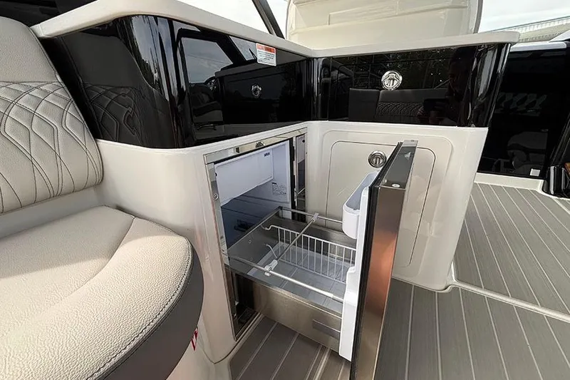 Slide: The Image of Interior view of 2026 Sea Ray Sundancer 370 Outboard with open refrigerator drawer. - 18
