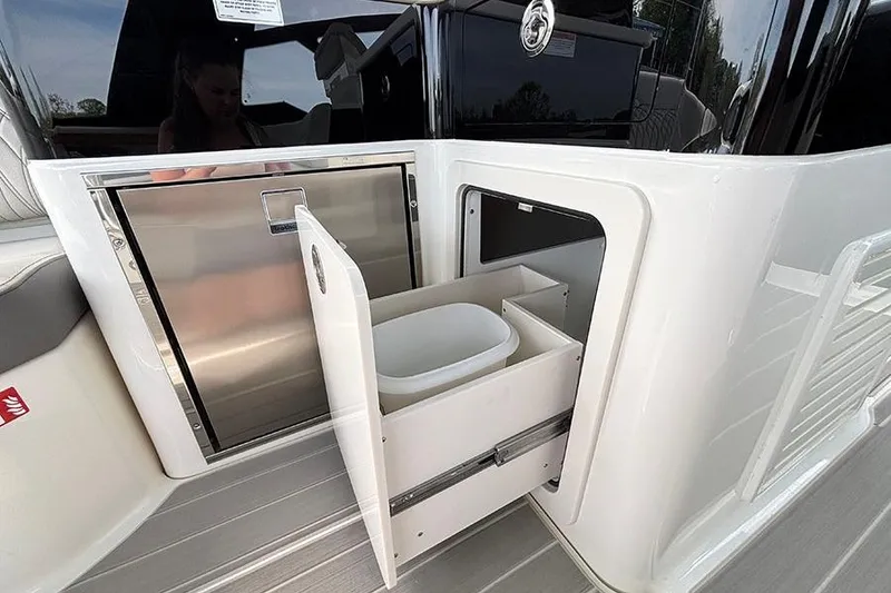 Slide: The Image of 2026 Sea Ray Sundancer 370 Outboard with open storage compartment and sleek design. - 19