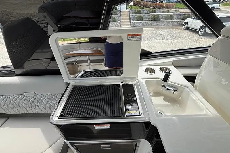 Slide: The Image of Outdoor kitchen area on 2026 Sea Ray Sundancer 370 Outboard yacht with grill and sink. - 20