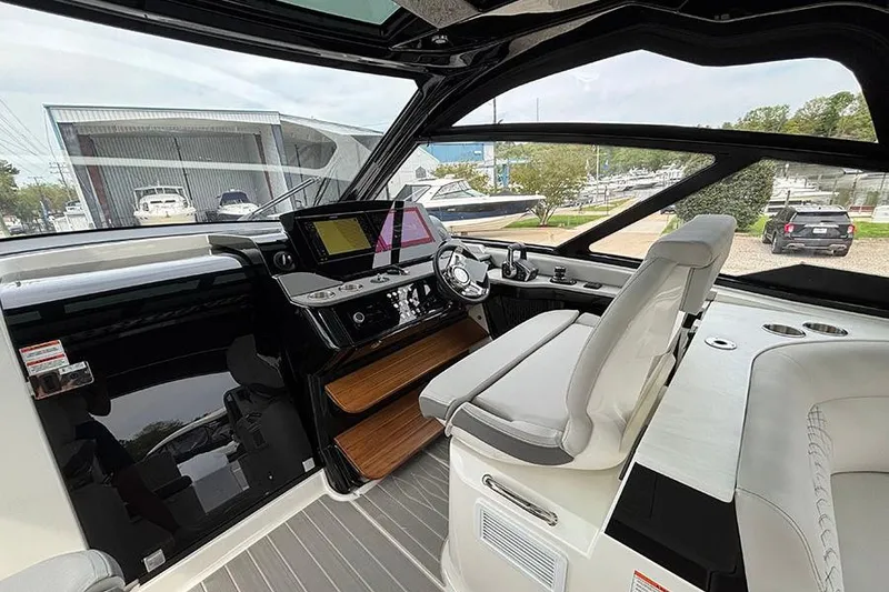 Slide: The Image of Interior of 2026 Sea Ray Sundancer 370 Outboard, featuring modern helm and luxurious seating. - 21