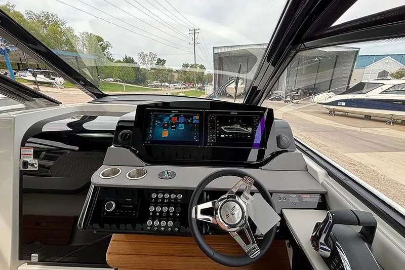 Slide: The Image of 2026 Sea Ray Sundancer 370 Outboard helm with advanced navigation display and controls. - 23