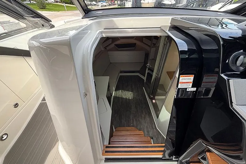 Slide: The Image of Interior view of 2026 Sea Ray Sundancer 370 Outboard cabin with wooden steps and modern design. - 27