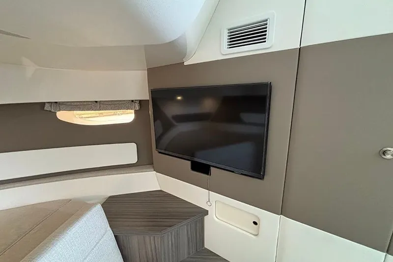 Slide: The Image of Interior of 2026 Sea Ray Sundancer 370 Outboard with mounted TV and modern design. - 30