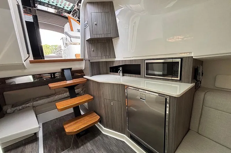 Slide: The Image of Interior of 2026 Sea Ray Sundancer 370 Outboard with kitchenette and modern amenities. - 32