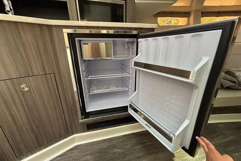 Slide: The Image of Open refrigerator inside 2026 Sea Ray Sundancer 370 Outboard yacht, showcasing modern interior design. - 33
