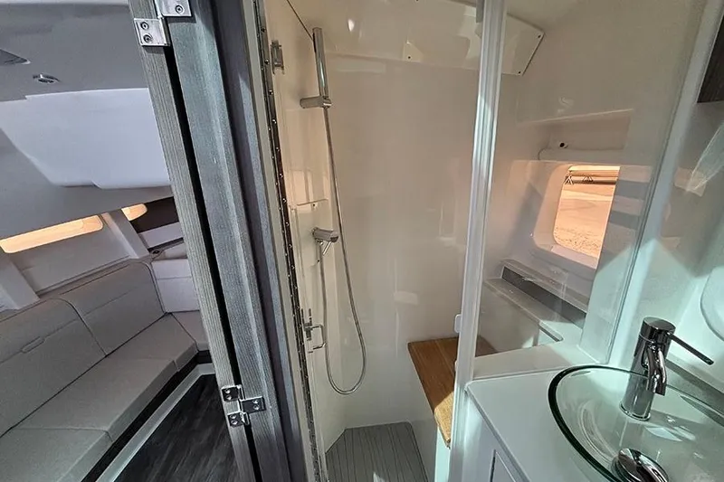 Slide: The Image of 2026 Sea Ray Sundancer 370 Outboard interior with modern shower and seating area. - 34