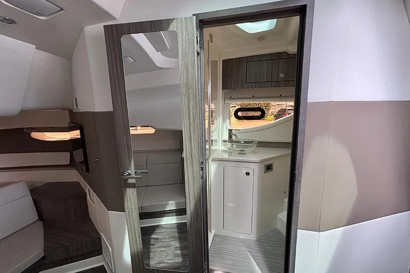 Slide: The Image of Interior of 2026 Sea Ray Sundancer 370 Outboard, featuring modern cabin and bathroom. - 35