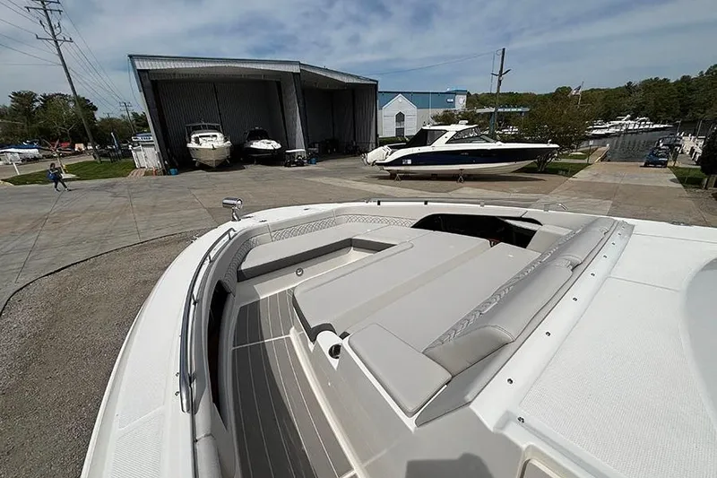 Slide: The Image of 2026 Sea Ray Sundancer 370 Outboard docked at marina, showcasing spacious deck and sleek design. - 39