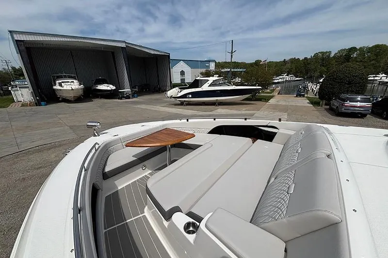 Slide: The Image of 2026 Sea Ray Sundancer 370 Outboard with spacious deck and seating at a marina. - 44