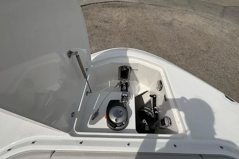 Slide: The Image of Anchor compartment of 2026 Sea Ray Sundancer 370 Outboard boat, featuring winch and storage. - 47