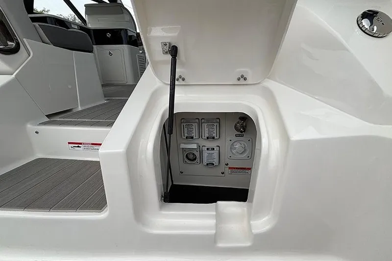 Slide: The Image of 2026 Sea Ray Sundancer 370 Outboard, open hatch revealing control panel and interior details. - 5