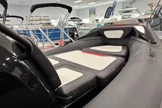 Slide: The Image of 2025 Highfield Velox 420 boat interior with cushioned seating in showroom. - 7