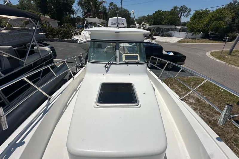 Slide: The Image of 1998 True World Marine TE286 boat with Garmin equipment, docked in a sunny marina. - 11