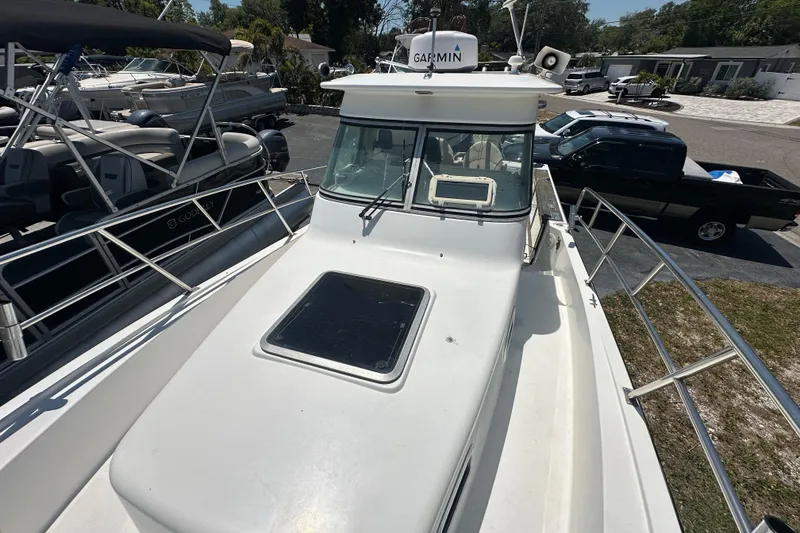 Slide: The Image of 1998 True World Marine TE286 boat with Garmin equipment, docked near other vessels. - 12