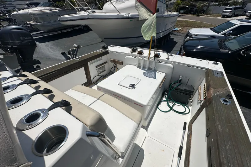 Slide: The Image of 1998 True World Marine TE286 boat interior with fishing rod holders and seating. - 14