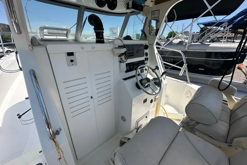 Slide: The Image of 1998 True World Marine TE286 boat cockpit with steering wheel and control panel. - 15