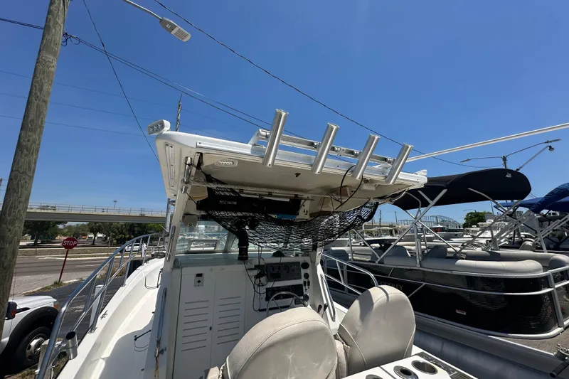 Slide: The Image of 1998 True World Marine TE286 boat with rod holders and seating, docked under clear blue sky. - 17