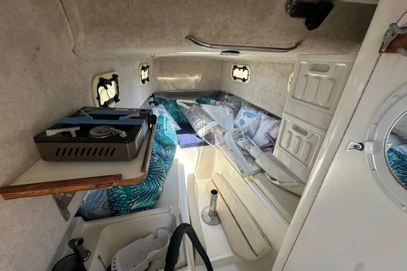 Slide: The Image of Interior cabin of a 1998 True World Marine TE286 boat, featuring cozy sleeping area. - 19