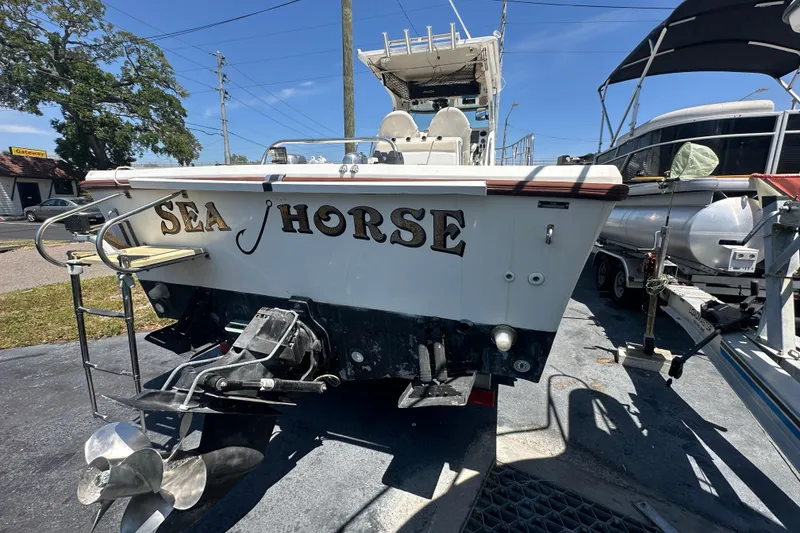 Slide: The Image of 1998 True World Marine TE286 boat named "Sea Horse" on display outdoors. - 2