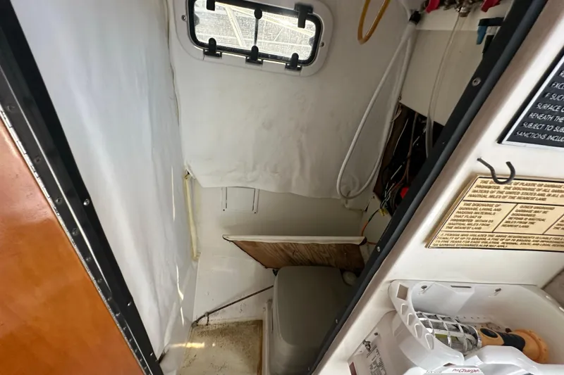 Slide: The Image of Interior of a 1998 True World Marine TE286 boat, featuring a compact cabin space. - 21