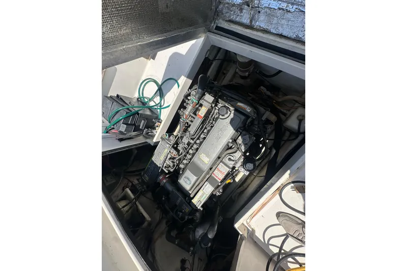 Slide: The Image of Engine compartment of a 1998 True World Marine TE286 boat, showcasing detailed machinery. - 8