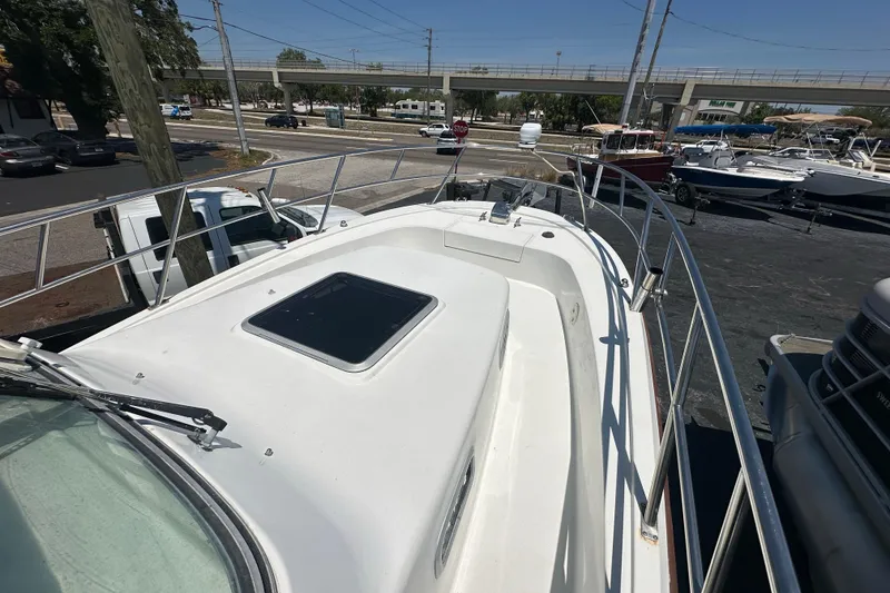 Slide: The Image of 1998 True World Marine TE286 boat deck with railing, parked near other boats. - 9