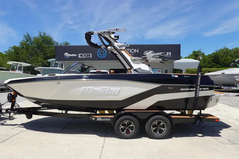 The Image of 2026 Malibu Wakesetter 21 LX boat on trailer, displayed outdoors. - 1