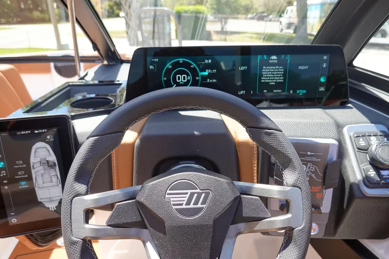 Slide: The Image of 2026 Malibu Wakesetter 21 LX dashboard with digital displays and steering wheel. - 10