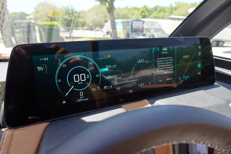 Slide: The Image of 2026 Malibu Wakesetter 21 LX digital dashboard display with speedometer and notifications. - 12