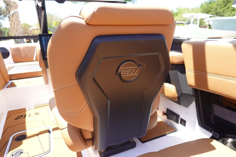 Slide: The Image of 2026 Malibu Wakesetter 21 LX interior with tan leather seats and sleek design. - 14