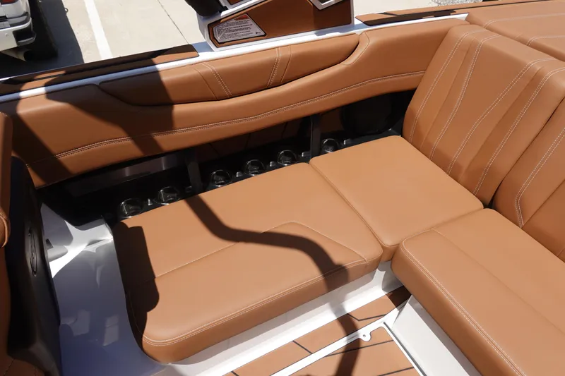 Slide: The Image of 2026 Malibu Wakesetter 21 LX interior with tan leather seating and cup holders. - 15