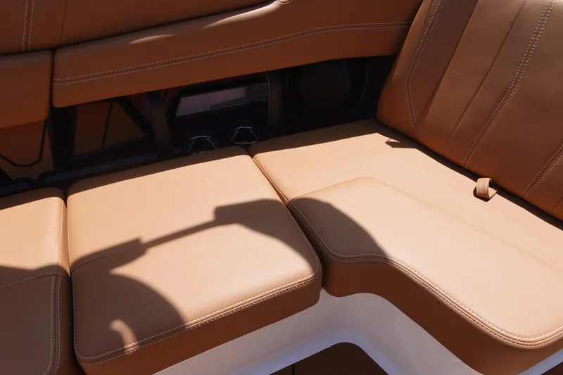 Slide: The Image of 2026 Malibu Wakesetter 21 LX interior with tan leather seating. - 18
