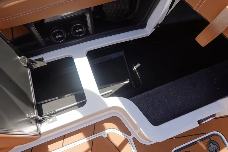 Slide: The Image of 2026 Malibu Wakesetter 21 LX storage compartments with open hatches and sleek interior design. - 26