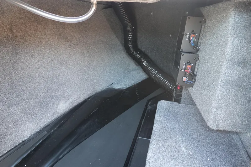 Slide: The Image of Interior view of 2026 Malibu Wakesetter 21 LX boat, showcasing wiring and carpeted surfaces. - 27