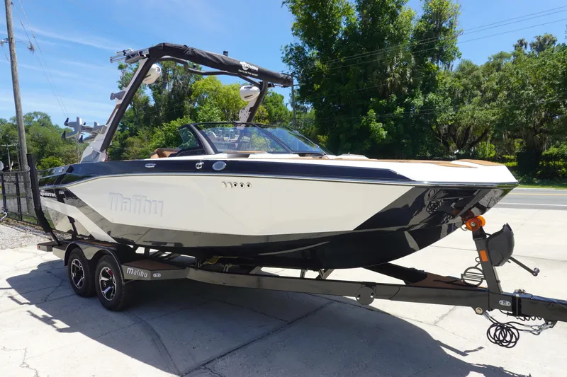 Slide: The Image of 2026 Malibu Wakesetter 21 LX boat on trailer, parked outdoors. - 3