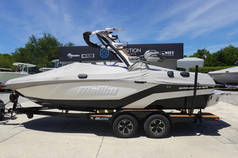 Slide: The Image of 2026 Malibu Wakesetter 21 LX boat on trailer, covered, outdoors under clear sky. - 39