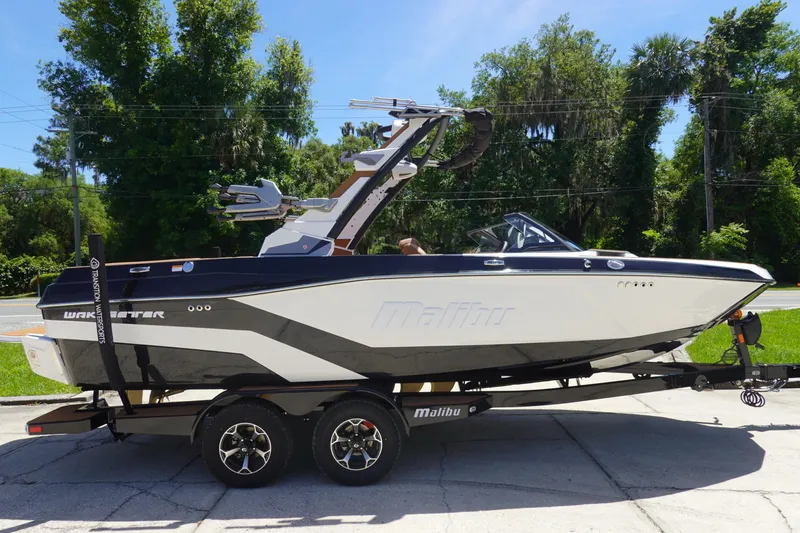 Slide: The Image of 2026 Malibu Wakesetter 21 LX boat on trailer, parked outdoors. - 4