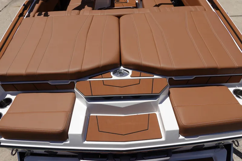 Slide: The Image of 2026 Malibu Wakesetter 21 LX boat with brown cushioned seating and sleek design. - 6