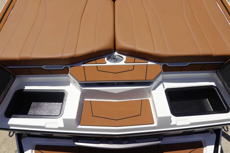 Slide: The Image of 2026 Malibu Wakesetter 21 LX boat interior with brown leather seating and storage compartments. - 7