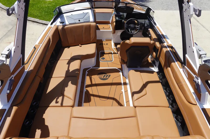 Slide: The Image of Interior of 2026 Malibu Wakesetter 21 LX boat with luxurious tan seating. - 8