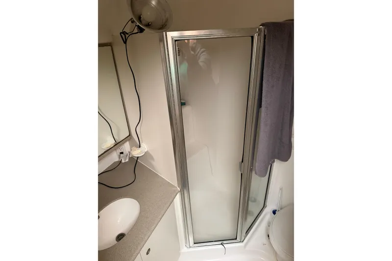 Slide: The Image of Bathroom interior of 1997 Silverton 442 Cockpit Motor Yacht with shower and sink. - 12