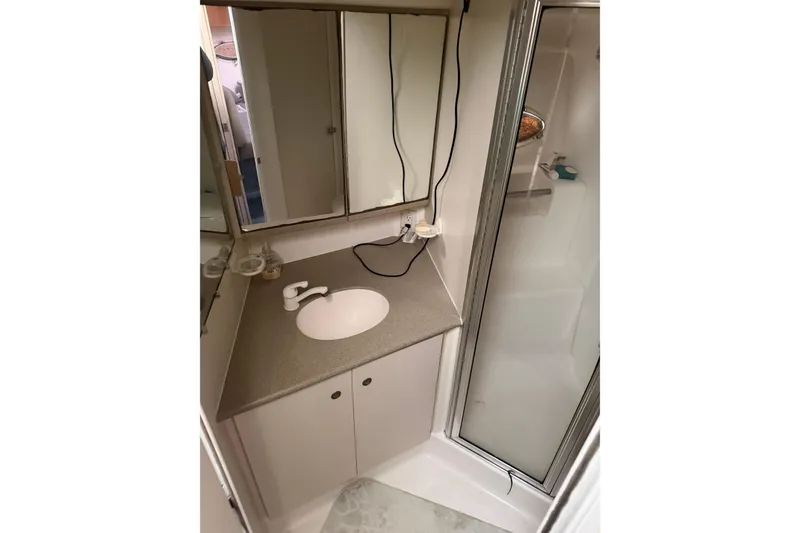 Slide: The Image of Bathroom interior of 1997 Silverton 442 Cockpit Motor Yacht with sink and shower. - 13
