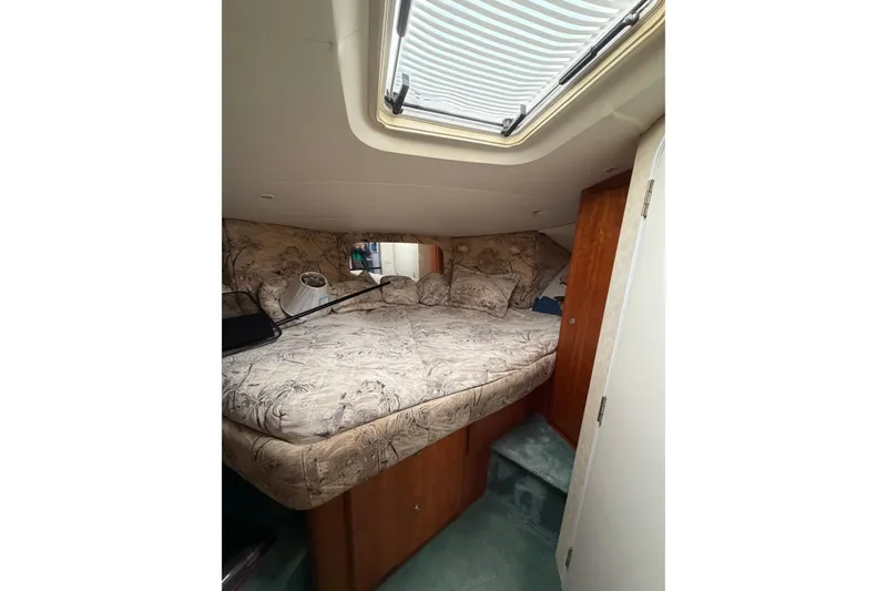 Slide: The Image of Luxurious cabin interior of 1997 Silverton 442 Cockpit Motor Yacht with patterned bedding. - 15