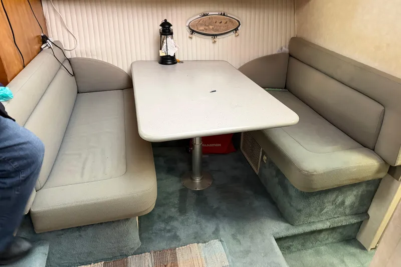 Slide: The Image of Interior of a 1997 Silverton 442 Cockpit Motor Yacht with cozy dining area. - 16